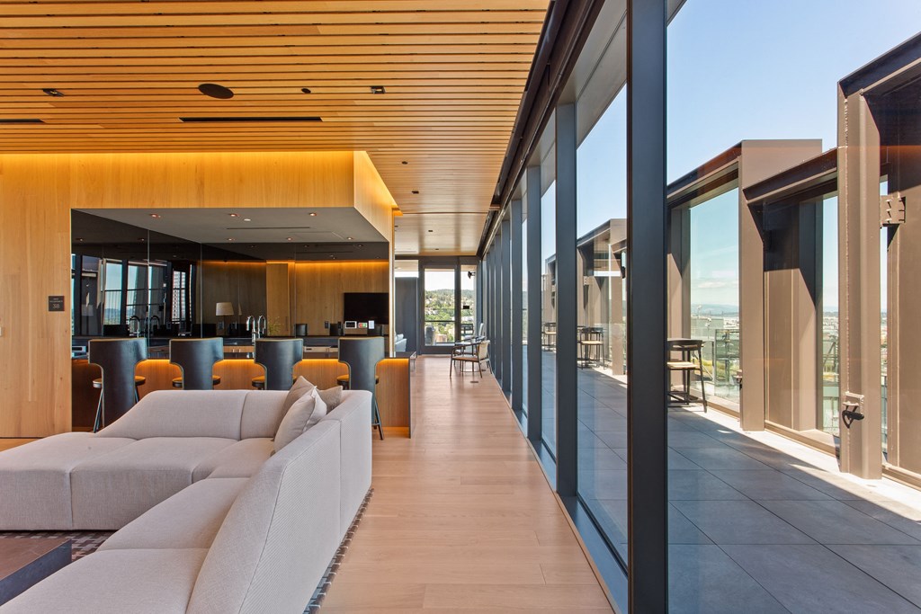 a living room filled with furniture and a large window