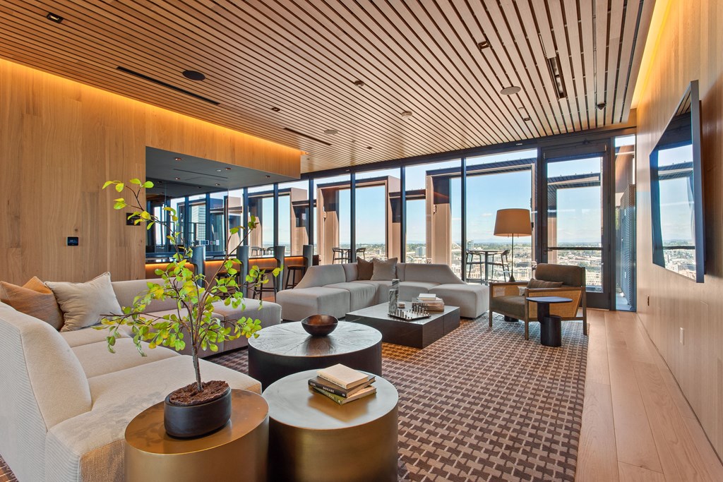 a living room filled with furniture and a large window