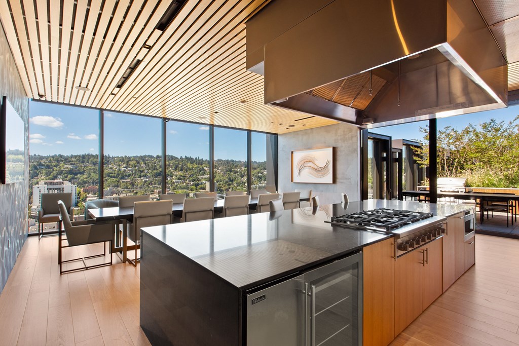 a kitchen with a large island and a view of the city
