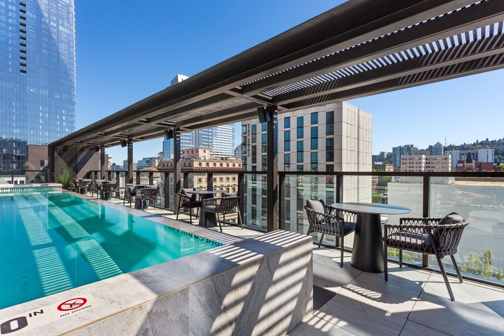 a rooftop pool with a view of the city