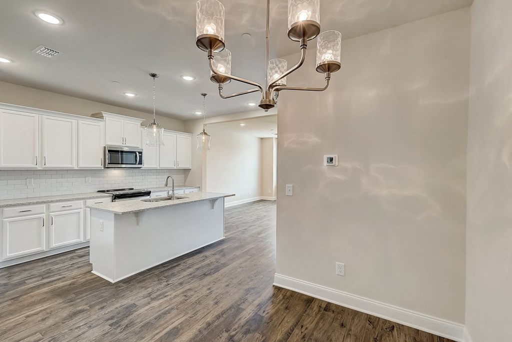 a kitchen and living room with a chandelier
