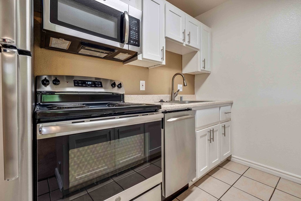 Apartments for Rent in Fremont CA - Lincoln Glen - Modern Kitchen with Tile Flooring, Stainless Steel Appliances, White Cabinetry, and Granite Counters