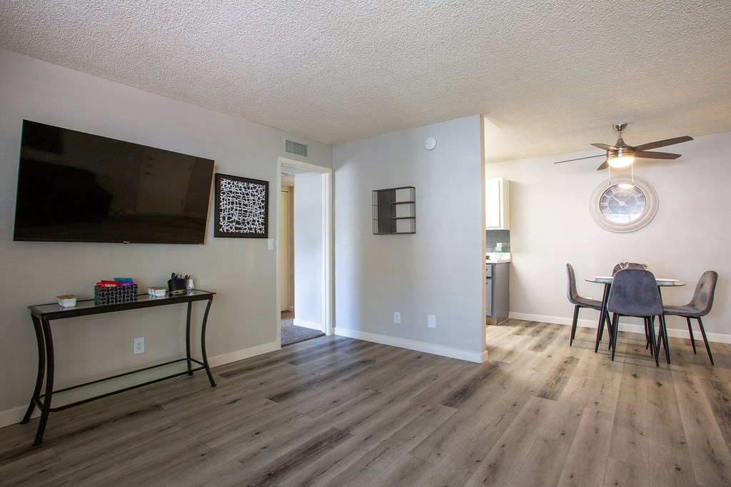 an open living room and dining room with a table and chairs