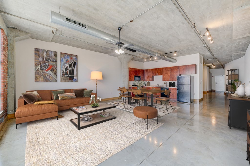 A living room with a brown couch and a coffee table.