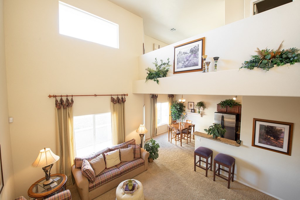 a living room with a couch and a table and a balcony