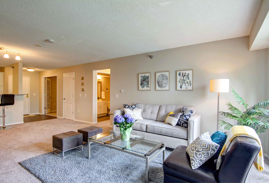 a living room with a couch and a glass table