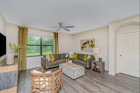 A living room with a couch, a chair, and a coffee table.