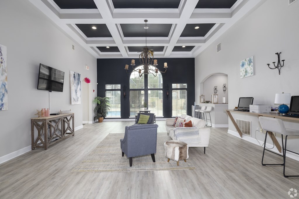2 & 3-Bedroom Apartments for Rent in Little Rock, AR – Capitol Hill – A modern living room with a grey sofa and a wooden floor.