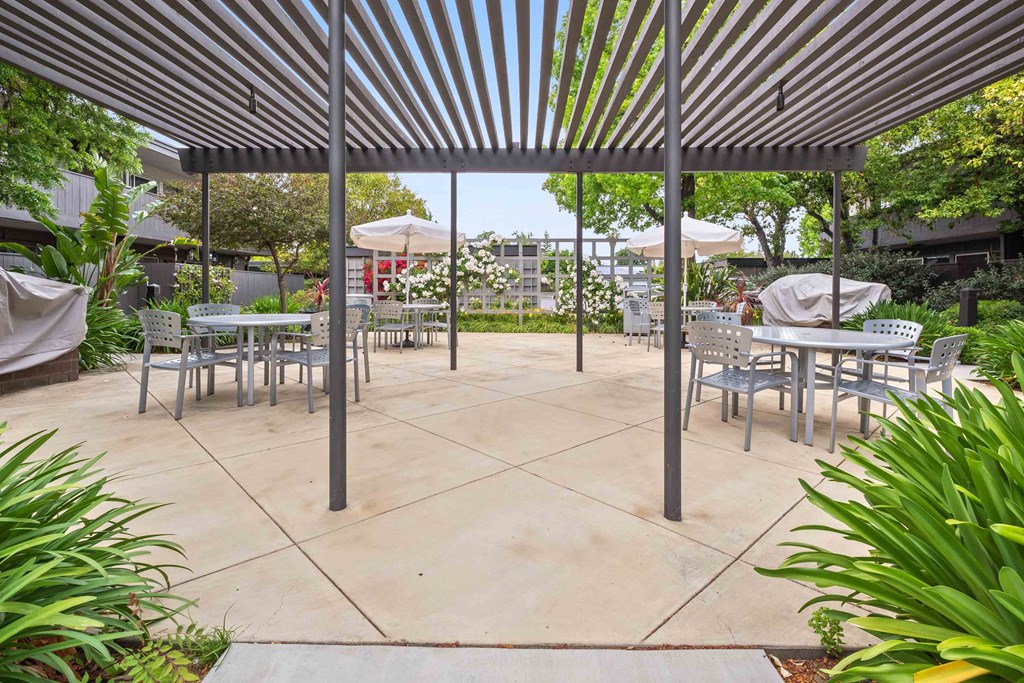 Fremont CA Apartments for Rent - Logan Park - Outdoor BBQ Area with Grilling Stations and Dining Tables Shaded by a Pergola