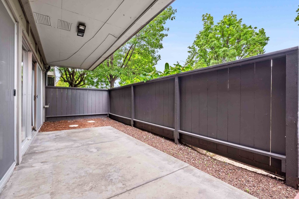 Fremont Apartments for Rent - Logan Park - Huge Patio with Concrete Floor, Wood Chips, and Privacy Fence