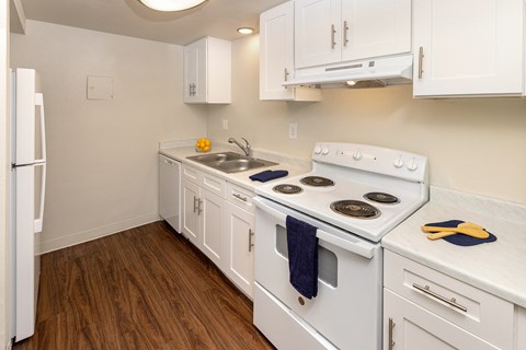 the preserve at ballantyne commons apartment kitchen with white appliances and white cabinets