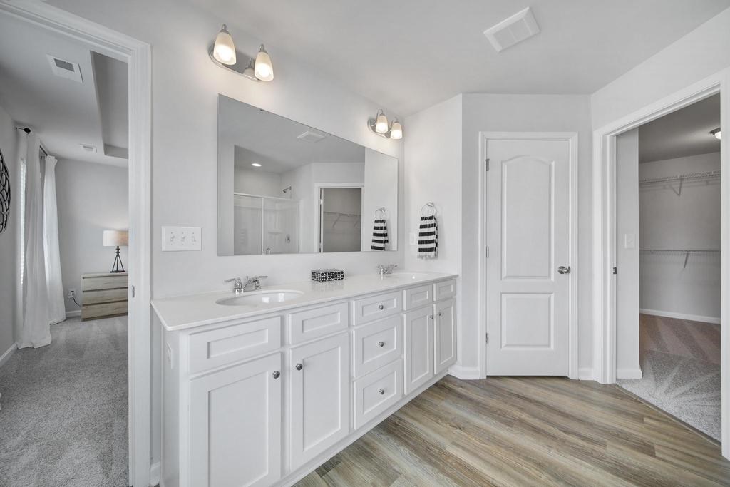 A bathroom with a vanity and a mirror.