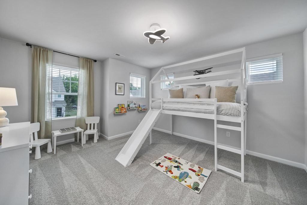 A room with a bunk bed and a slide.