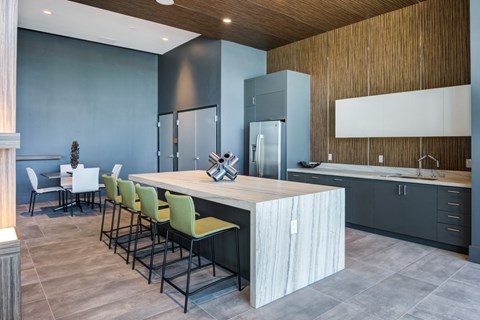a kitchen with a large island and a dining table with chairs