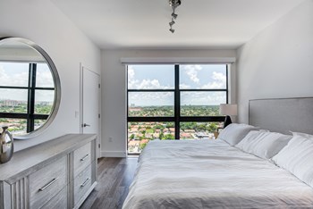 Two Bedroom Apartments in Miami FL - MB Station - Bright Bedroom with Grey Hardwood Flooring and a Large Side Window - Photo Gallery 2