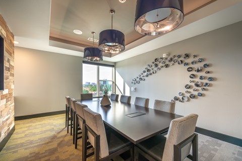 A modern dining room with a large table and chairs.