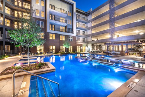 A large indoor swimming pool with a slide in a residential building.