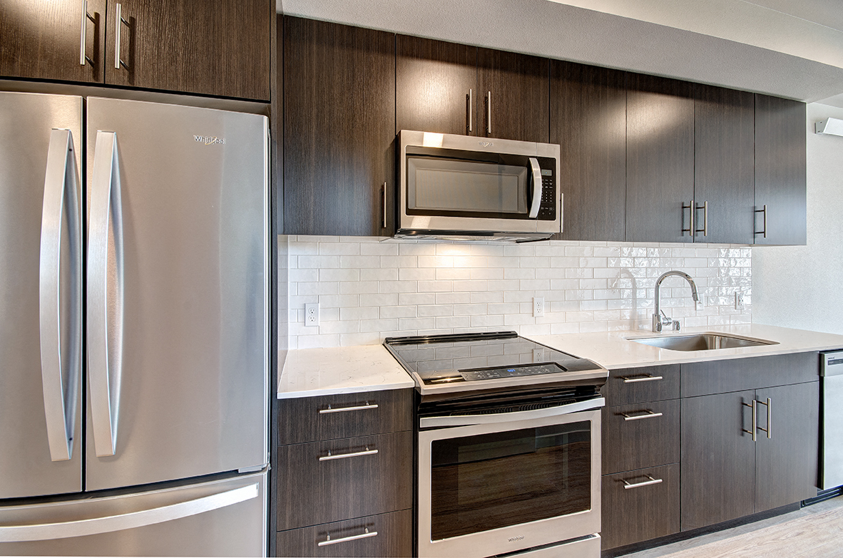Downtown Seattle WA Apartments-Metroline Flats Apartments Kitchen With Wooden Cabinetry And White Tile Backsplash