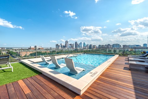 A rooftop pool with a city skyline in the background.
