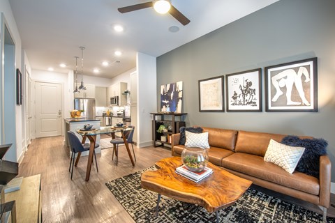 A living room with a brown couch and a coffee table.