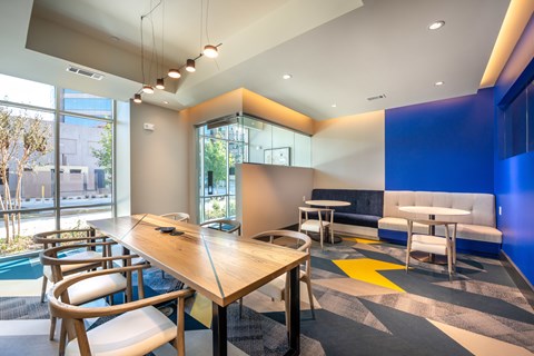A conference room with a long table and chairs.