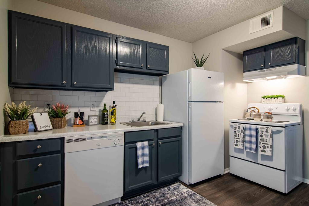 Kitchen with white appliances and ample cabinet space at Mableton Ridge Apartments in Mableton, GA, near Douglasville.