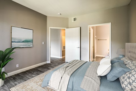 a bedroom with a bed and a door to a bathroom