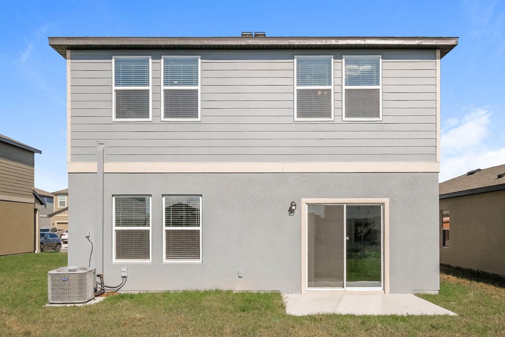 A grey house with a white door and windows.