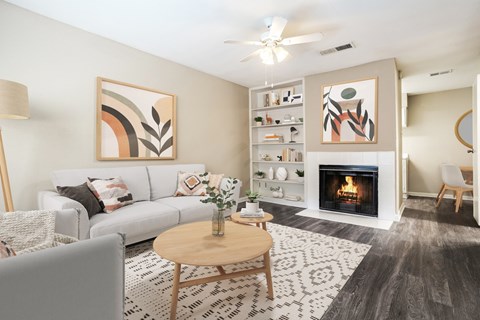A living room with a fireplace and a painting on the wall.