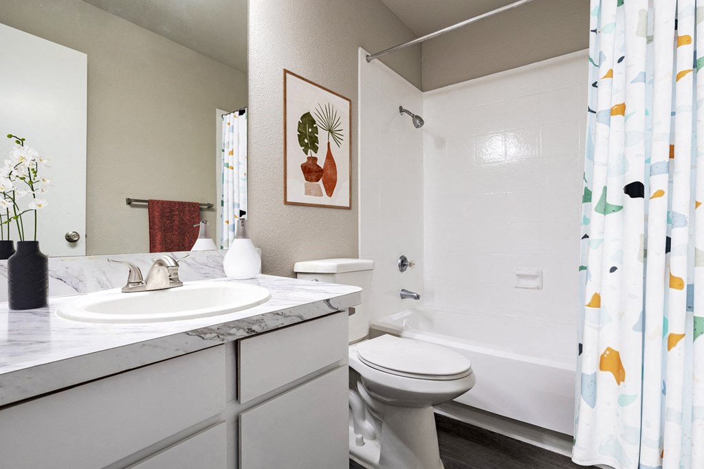 Bathroom with shower and tub at Magnolia Terrace, a pet-friendly apartment community in Far West Houston, Houston, TX.