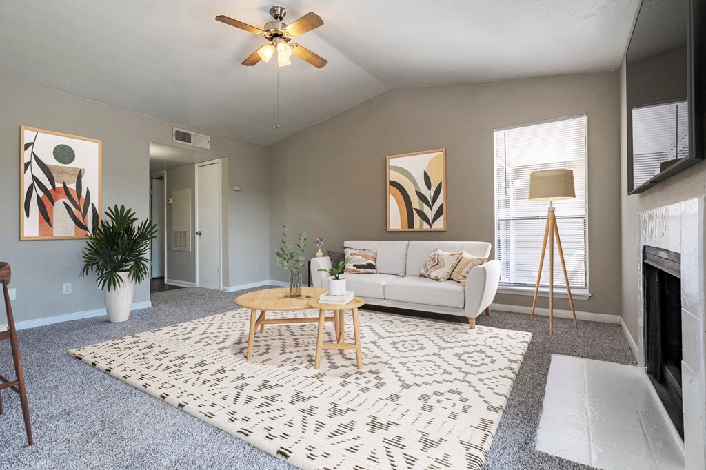 Living room with large window and soft, plush carpeting at Magnolia Terrace, a pet-friendly apartment community in Far West Houston, Houston, TX.