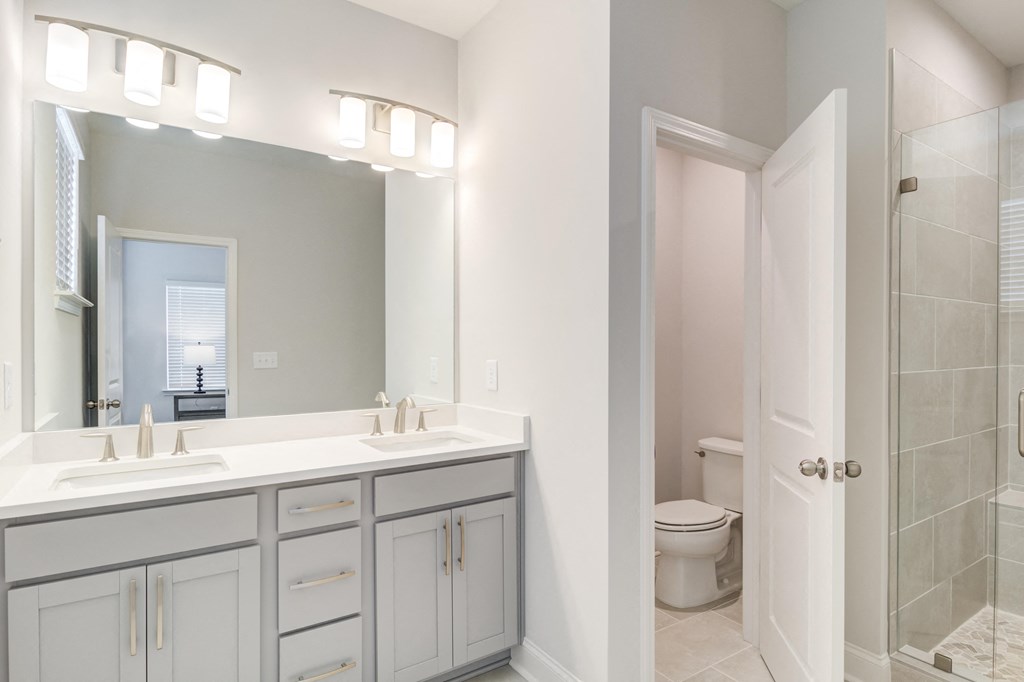a bathroom with a sink and a toilet and a mirror