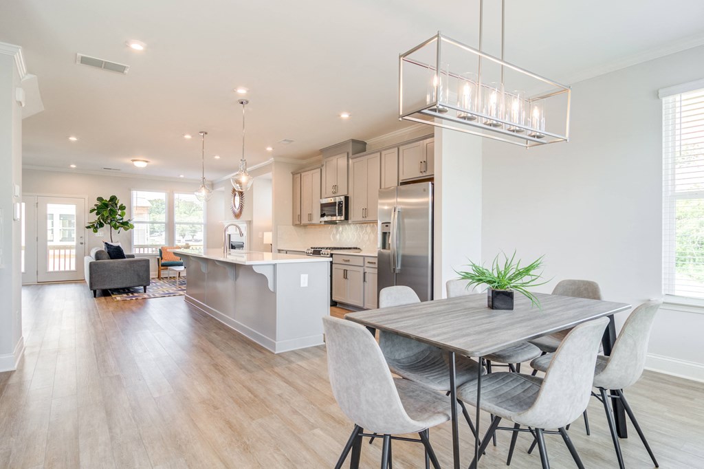 a kitchen and dining room with a table and chairs