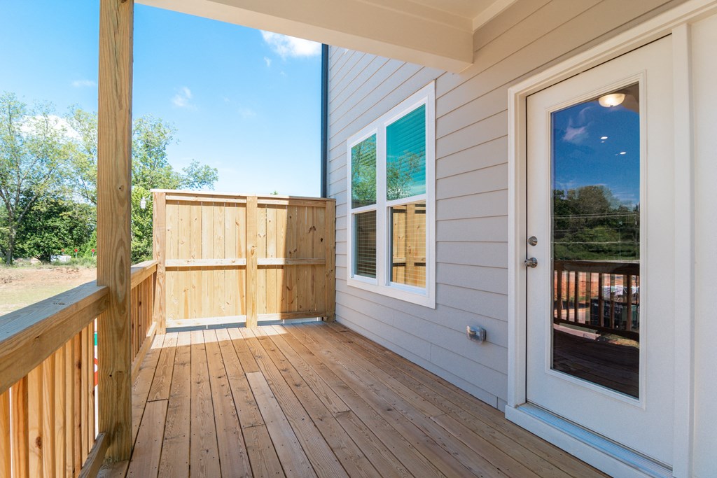 the deck of a home with a door and a window