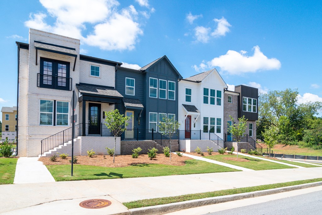 a row of new town houses on a sidewalk