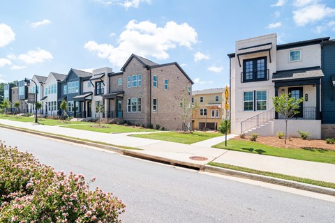 A row of houses with a street in front.