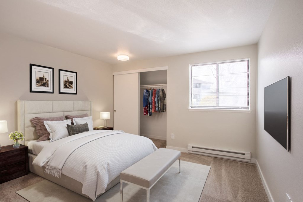 a bedroom with a bed and a tv