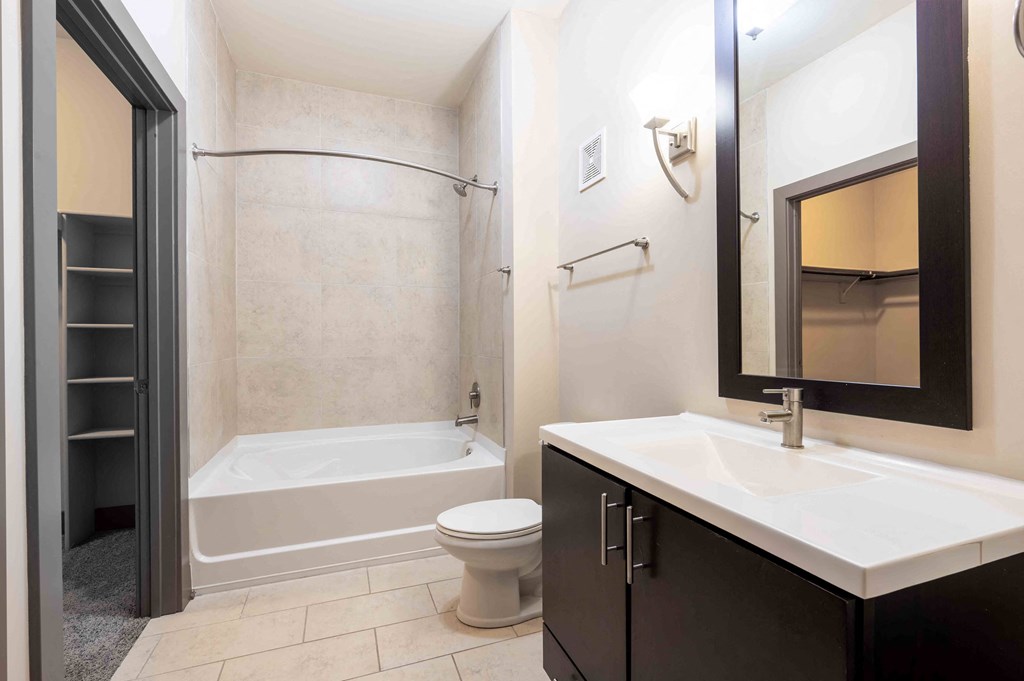 a bathroom with a sink toilet and a bath tub