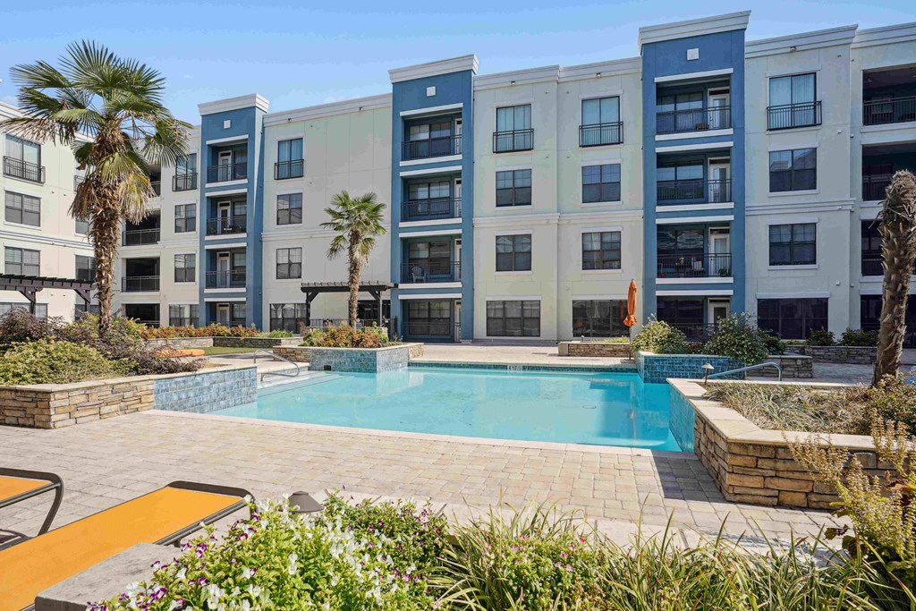 Apartments for Rent in North Little Rock, AR 72114– Metropolitan- A pool surrounded by a patio and a building.