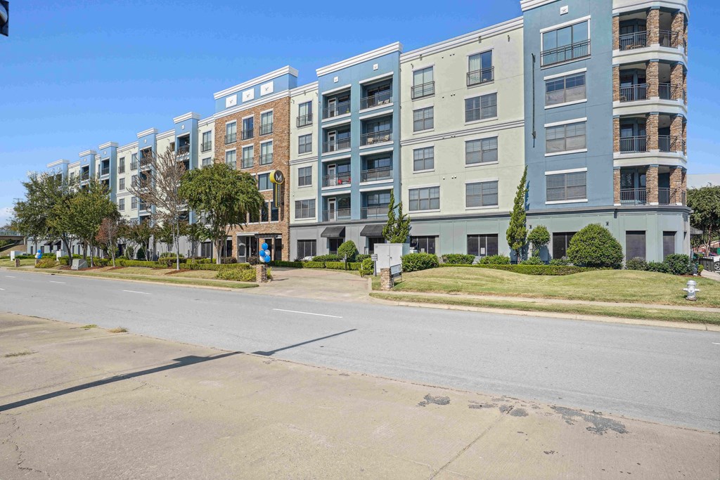 1, 2 -Bedroom Apartments for Rent in North Little Rock, AR – Metropolitan– A row of modern apartment buildings are lined up on a street.