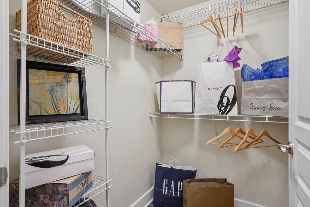 Pet-Friendly Rentals in North Little Rock, AR – Metropolitan – A white closet with a GAP bag and a MINE WEST bag.