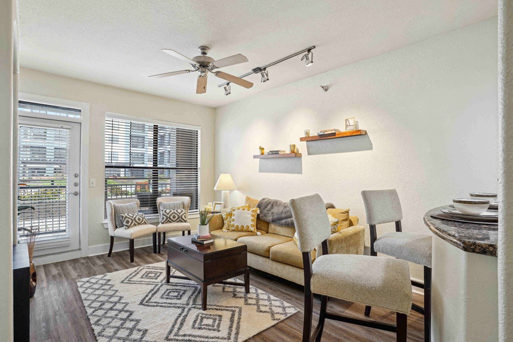 Apartments for Rent in North Little Rock, AR 72114– Metropolitan-   A living room with a couch, chairs, and a rug.