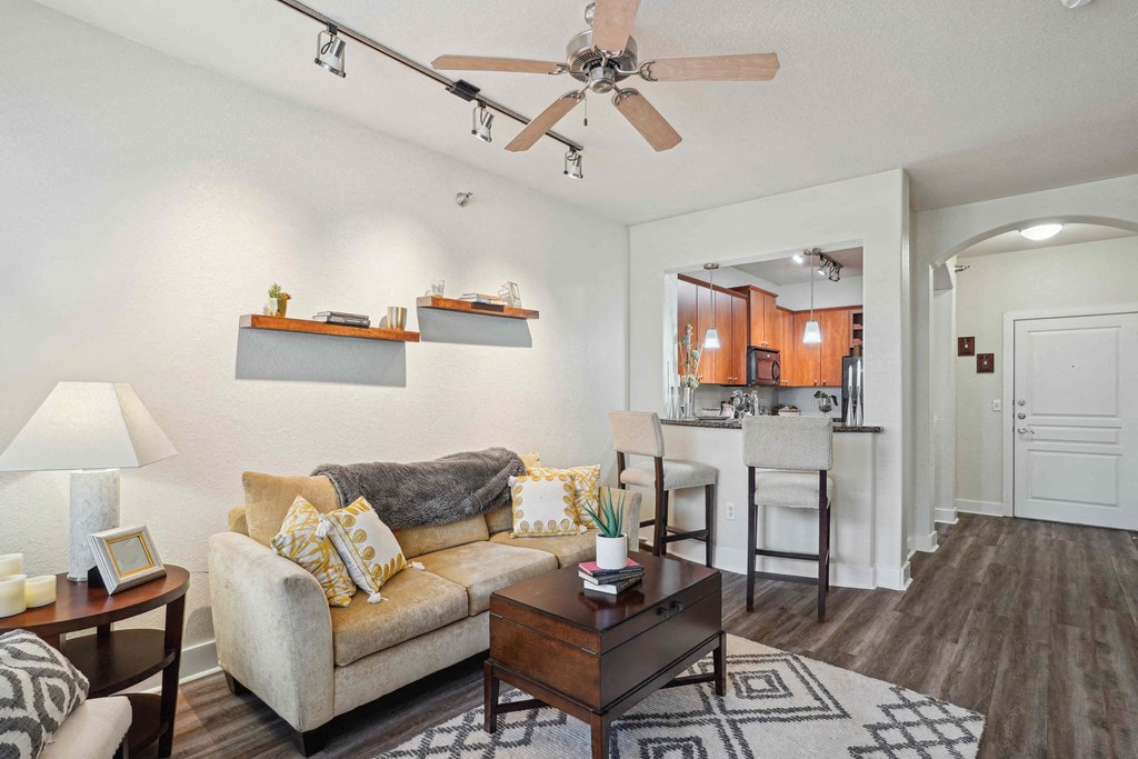 Pet-Friendly Rentals in North Little Rock, AR – Metropolitan – A living room with a couch, a coffee table, and a ceiling fan.
