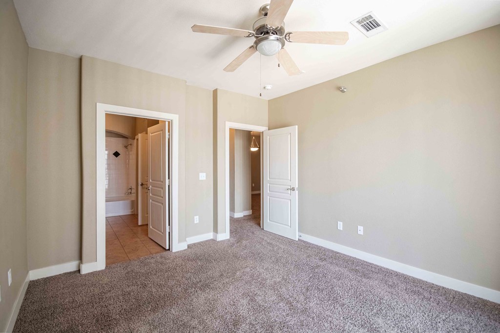 a bedroom with a ceiling fan At Metropolitan Apartments in Little Rock, AR