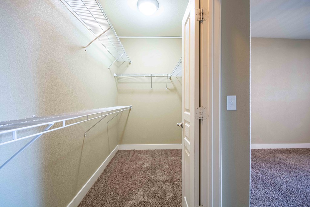 a walk in closet in a bedroom plus bedroom At Metropolitan Apartments in Little Rock, AR
