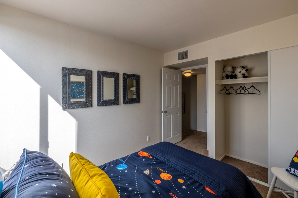 Bedroom with large closet and window at Midtown on Seneca, a pet-friendly apartment community near East Central Tucson, Tucson, AZ.