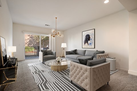 an open living room with a gray and white striped rug and a couch and chairs