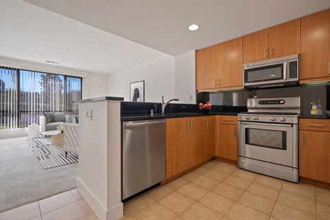 a modern kitchen with stainless steel appliances and wooden cabinets
