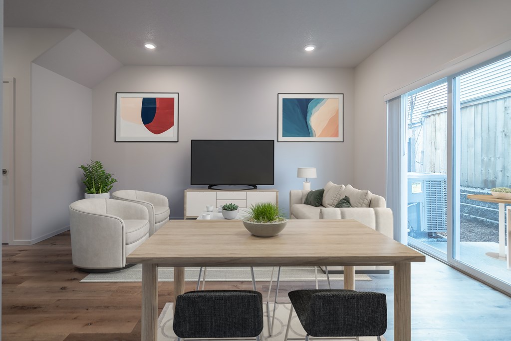 A modern living room with a wooden dining table and chairs.