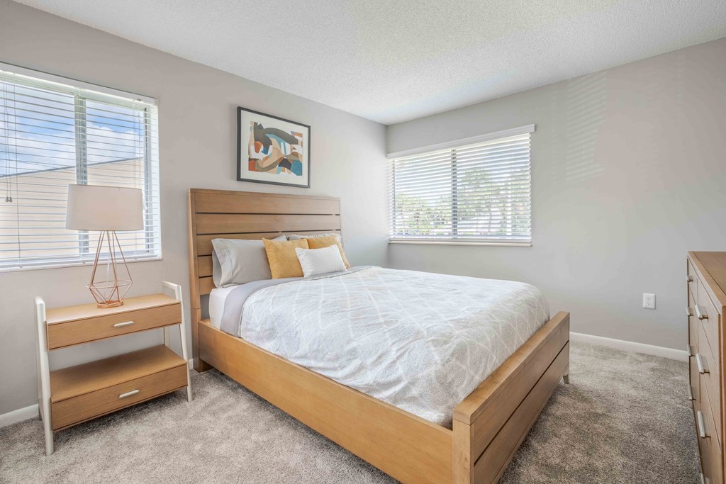 Kissimmee, Florida Apartments - Mirador at Woodside - Bedroom with Large Windows and Plush Carpeting